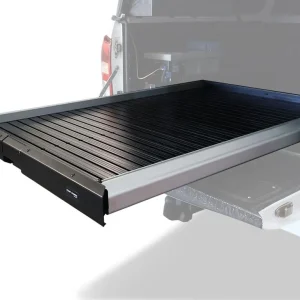 Front Runner Cargo Bed Slide / Medium – Wolf Customs | 4x4 Accessories and Fitment Slide-out cargo bed tray extended from a pickup truck, black slatted platform for loading gear